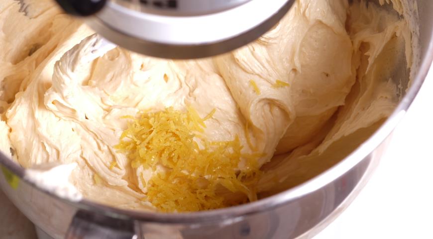 В тесто просеиваем муку с разрыхлителем постоянно помешивая, добавляем цедру лимона