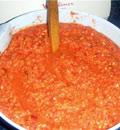 Добавить к измельченным ингредиентам томатную пасту для усиления цвета аджики