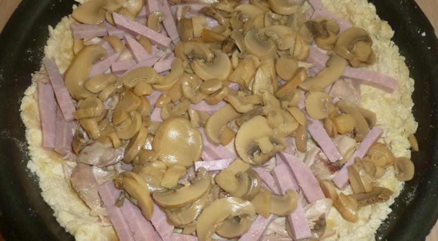 Выкладываем грибы, ветчину и курицу на тесто для киша в форму для выпекания