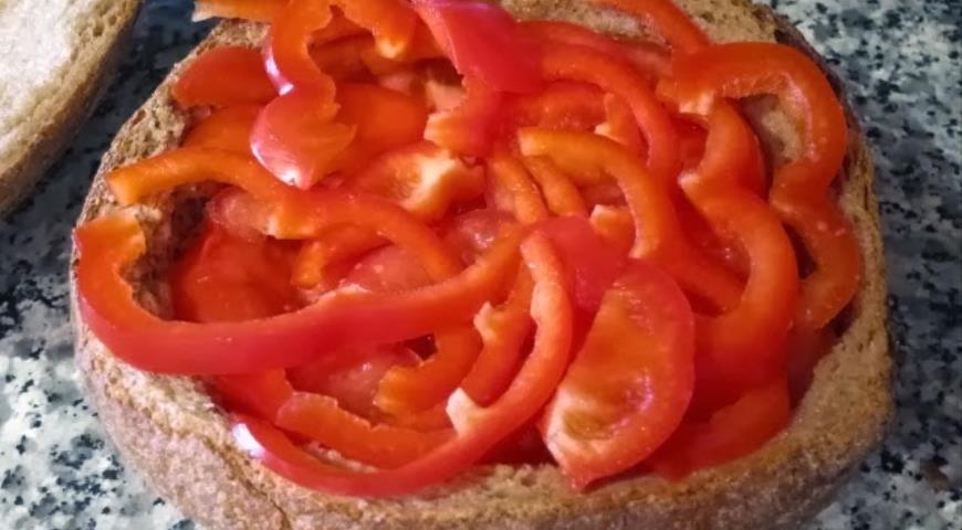 На булку выкладываем помидоры и сладкий перец